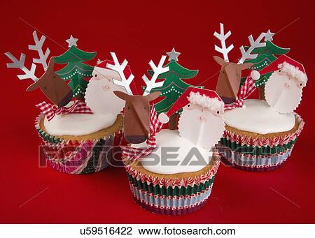Three White Iced Sponge Cupcakes In Paper Case Topped With Father Christmas, Reindeer And Christmas Tree, Red Background View Large Photo Image Stock Image - Three White Iced Sponge Cupcakes In Paper Case Topped With Father Christmas, Reindeer And Christmas Tree, Red Background. Fotosearch