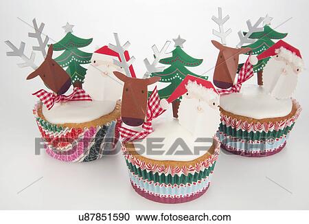 Three White Iced Sponge Cupcakes In Paper Cases Topped With Father Christmas, Reindeer And Christmas Tree, White Background View Large Photo Image Stock Image - Three White Iced Sponge Cupcakes In Paper Cases Topped With Father Christmas, Reindeer And Christmas Tree, White Background. Fotosearch