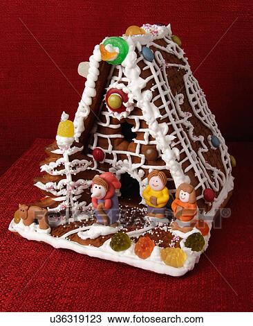 Traditional Gingerbread Biscuit House Decorated With Assorted Candy And Iced Character Figures, On Red Background View Large Photo Image Stock Image - Traditional Gingerbread Biscuit House Decorated With Assorted Candy And Iced Character Figures, On Red Background. Fotosearch