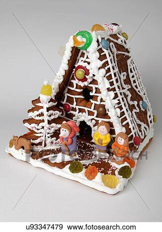 Traditional Gingerbread Biscuit House Decorated With Assorted Candy And Iced Character Figures, On White Background View Large Photo Image Stock Photo - Traditional Gingerbread Biscuit House Decorated With Assorted Candy And Iced Character Figures, On White Background. Fotosearch