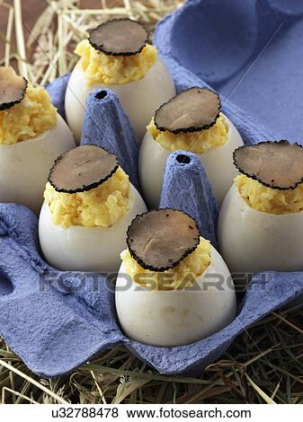 Stock Photo - Truffle scrambled eggs in a carton. Fotosearch