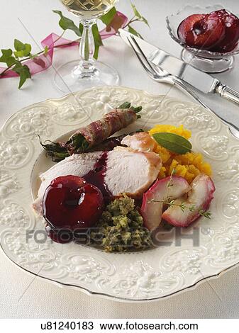 Stock Image - Turkey slices with roast apples herb stuffing plum with plum sauce sweet potato mash French beans wrapped in pancetta. Fotosearch