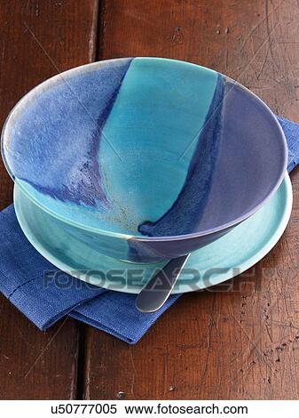 Turquoise empty craft pottery bowl on a wooden background View Large Photo Image Stock Photography - Turquoise empty craft pottery bowl on a wooden background. Fotosearch