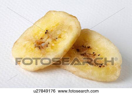 Stock Photograph - Two Dried Banana Chips On White. Fotosearch