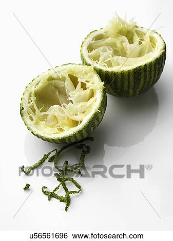 Two lime halves and zest on a white background View Large Photo Image Stock Photograph - Two lime halves and zest on a white background. Fotosearch
