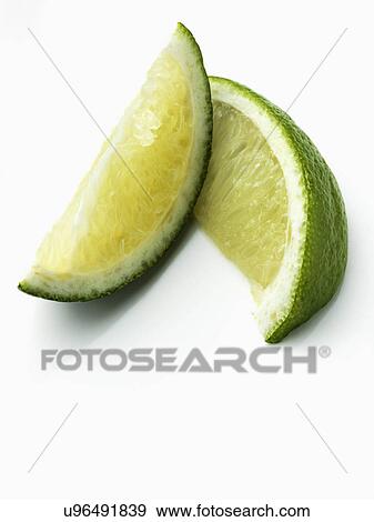 Two lime slices on a white background View Large Photo Image Stock Photo - Two lime slices on a white background. Fotosearch