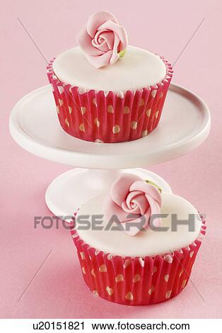 Two Perfect White Iced Cupcakes In Pink Polka Dot Cake Cases Decorated With Single Sugar Craft Rose, One Cake On White Cake Stand, Pink Tabletop View Large Photo Image Stock Image - Two Perfect White Iced Cupcakes In Pink Polka Dot Cake Cases Decorated With Single Sugar Craft Rose, One Cake On White Cake Stand, Pink Tabletop. Fotosearch