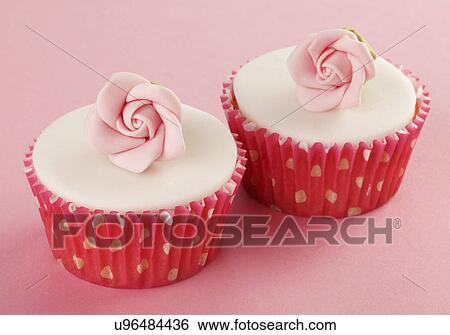Two Perfect White Iced Cupcakes In Pink Polka Dot Cake Cases Decorated With Single Sugar Craft Rose, On Pink Tabletop View Large Photo Image Stock Photograph - Two Perfect White Iced Cupcakes In Pink Polka Dot Cake Cases Decorated With Single Sugar Craft Rose, On Pink Tabletop. Fotosearch