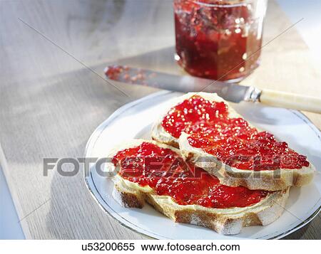 Two slices of bread spread with homemade jam View Large Photo Image Stock Photography - Two slices of bread spread with homemade jam. Fotosearch