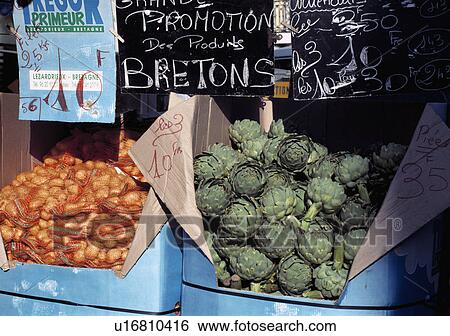 Stock Photograph - Vegetables artichokes potatoes at local market in France.. Fotosearch