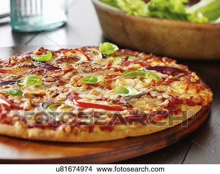 vegetarian pizza on table with salad View Large Photo Image Picture - vegetarian pizza on table with salad. Fotosearch