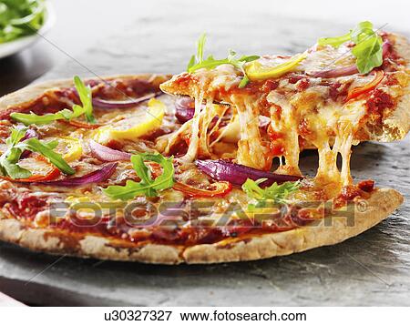 Vegetarian pizza with slice being cut View Large Photo Image Stock Photo - Vegetarian pizza with slice being cut. Fotosearch