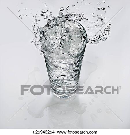 Water splashing out of a glass with ice View Large Photo Image Picture - Water splashing out of a glass with ice. Fotosearch