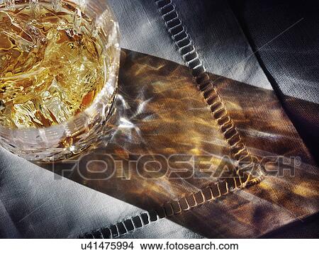 Picture - Whisky and ice in glass from above. Fotosearch