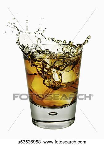whisly splashing from glass as ice is dropped in View Large Photo Image Stock Photo - whisly splashing from glass as ice is dropped in. Fotosearch