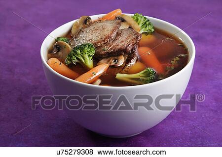 Stock Photo - White Bowl Filled With Beef, Carrot, And Broccoli Broth Or Casserole. Fotosearch