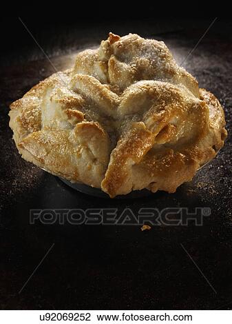 Stock Image - Whole home made apple pie on a baking tray. Fotosearch