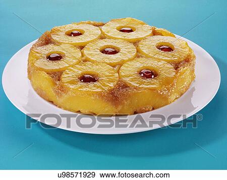 Whole Pineapple Upside Down Cake With Cherry Garnish, On White Plate With Blue Tabletop View Large Photo Image Stock Photo - Whole Pineapple Upside Down Cake With Cherry Garnish, On White Plate With Blue Tabletop. Fotosearch