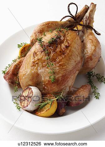 Stock Photograph - Whole roast chicken. Fotosearch