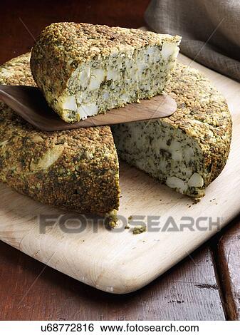 Whole Spinach tortilla with a slice on top View Large Photo Image Stock Photograph - Whole Spinach tortilla with a slice on top. Fotosearch