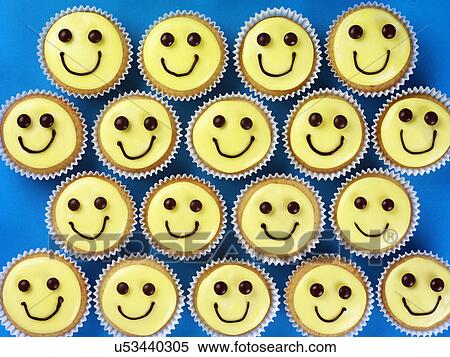 Yellow Iced Cupcakes Decorated With Smiley Happy Faces, On Blue View Large Photo Image Stock Photography - Yellow Iced Cupcakes Decorated With Smiley Happy Faces, On Blue. Fotosearch