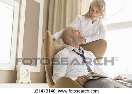 Loving mid adult business couple looking at each other at home View Large Photo Image Stock Photo - Loving mid adult business couple looking at each other at home. Fotosearch