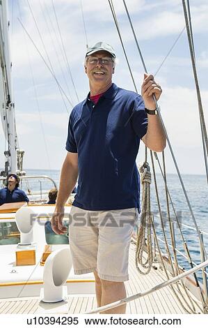 Portrait of happy middle-aged man standing on sailing yacht View Large Photo Image Stock Photography - Portrait of happy middle-aged man standing on sailing yacht. Fotosearch