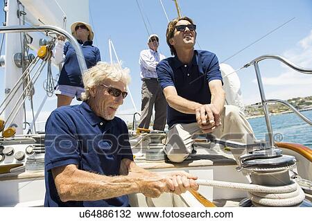 Sailing crew turning crank handle on yacht View Large Photo Image Stock Image - Sailing crew turning crank handle on yacht. Fotosearch