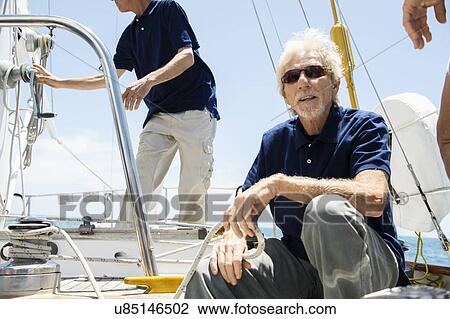 Sailing crew working on yacht View Large Photo Image Stock Image - Sailing crew working on yacht. Fotosearch