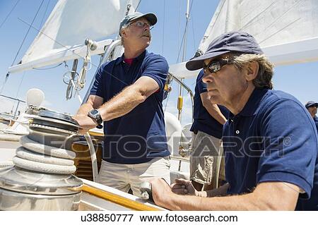 Sailing crew working together on yacht View Large Photo Image Stock Photo - Sailing crew working together on yacht. Fotosearch