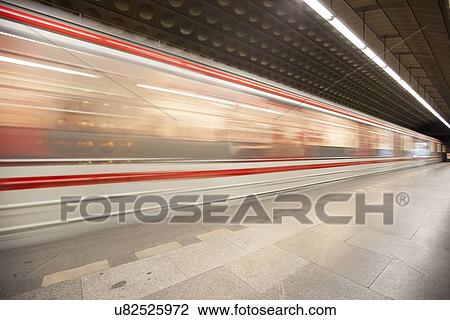 Stock Image - Train passing through subway station. Fotosearch