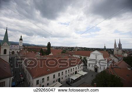 Stock Photo - View of churches and townscape against cloudy sky, Zagreb, Croatia. Fotosearch