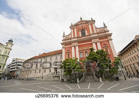 Stock Photograph - View of Franciscan Church of the Annunciation against cloudy sky, Slovenia, Ljubljana. Fotosearch