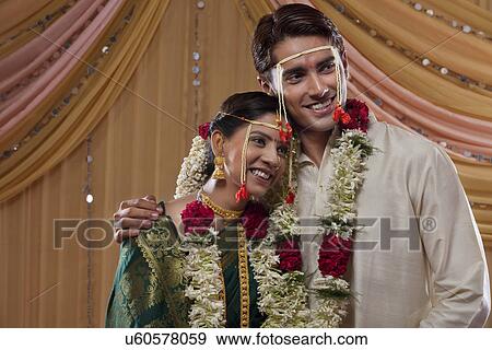 Stock Photo - Affectionate young married couple smiling together . Fotosearch