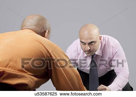 Stock Photography - Bald businessmen competing . Fotosearch
