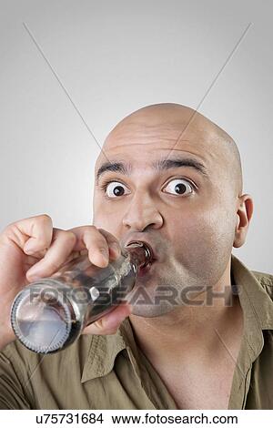 Bald man having a drink View Large Photo Image Picture - Bald man having a drink . Fotosearch