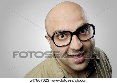 Bald man making a funny face View Large Photo Image Stock Image - Bald man making a funny face . Fotosearch