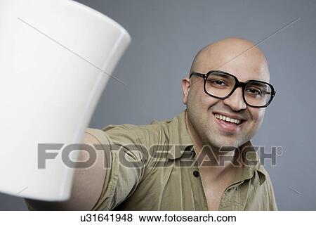 Bald man with a mug of tea View Large Photo Image Stock Photo - Bald man with a mug of tea . Fotosearch