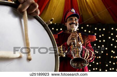 Bandmaster holding a trumpet View Large Photo Image Stock Image - Bandmaster holding a trumpet . Fotosearch