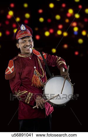 Stock Image - Bandmaster playing on drums . Fotosearch