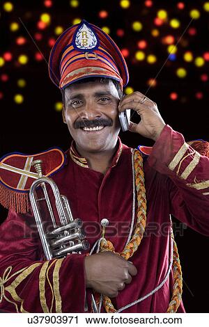 Bandmaster talking on a mobile phone View Large Photo Image Stock Image - Bandmaster talking on a mobile phone . Fotosearch