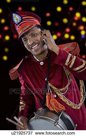 Bandmaster talking on a mobile phone View Large Photo Image Stock Photo - Bandmaster talking on a mobile phone . Fotosearch