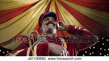 Stock Photography - Bandmaster talking on a mobile phone . Fotosearch