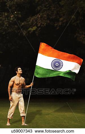 Bare chested man holding the Indian flag View Large Photo Image Stock Image - Bare chested man holding the Indian flag . Fotosearch
