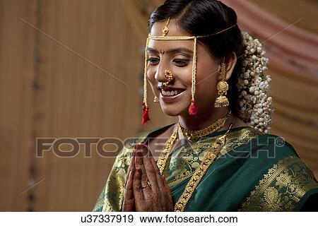 Beautiful Maharashtrian bride praying on her wedding day View Large Photo Image Stock Photo - Beautiful Maharashtrian bride praying on her wedding day . Fotosearch