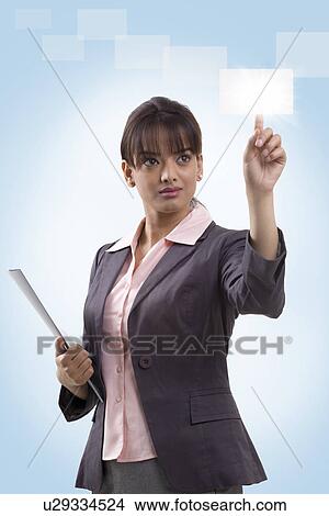 Beautiful young businesswoman using hi-tech computer monitor View Large Photo Image Picture - Beautiful young businesswoman using hi-tech computer monitor . Fotosearch