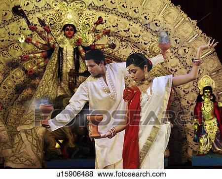 Bengali couple doing a Dhunuchi dance View Large Photo Image Stock Photo - Bengali couple doing a Dhunuchi dance . Fotosearch