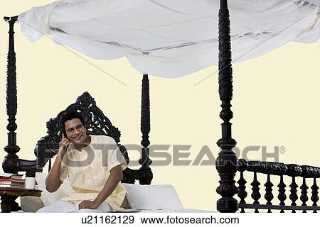 Stock Photo - Bengali man talking on a mobile phone . Fotosearch