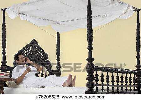 Stock Photo - Bengali man talking on a mobile phone . Fotosearch