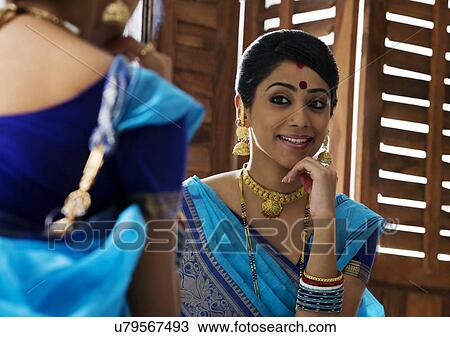 Bengali woman admiring herself in a mirror View Large Photo Image Stock Image - Bengali woman admiring herself in a mirror . Fotosearch